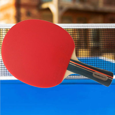 Powerkraft Rakshak racket with red rubber on a blue table tennis table