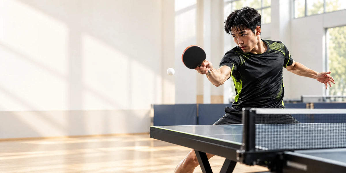 Table tennis racket and ball on a light table tennis surface